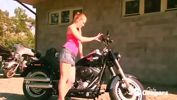 Horny Jenna Haven doing striptease on black bike