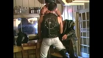 Three bikers in leather sucking cocks of each other in bar